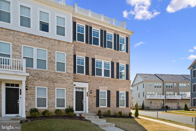 view of property with brick siding and a residential view