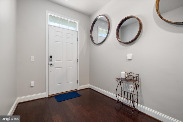 entryway featuring dark wood-style floors and baseboards