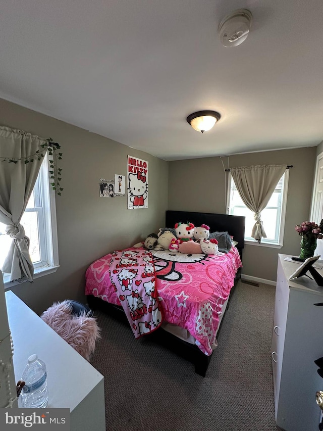 carpeted bedroom with visible vents and baseboards