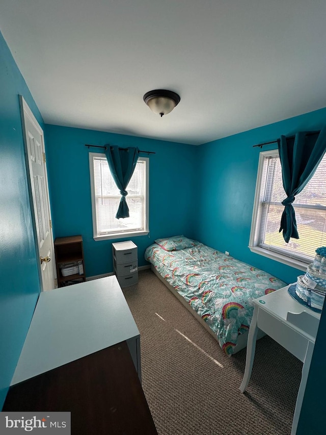 bedroom with carpet flooring and multiple windows