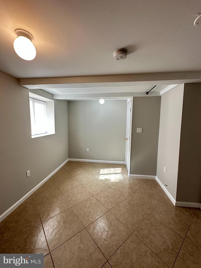 unfurnished room with tile patterned flooring and baseboards