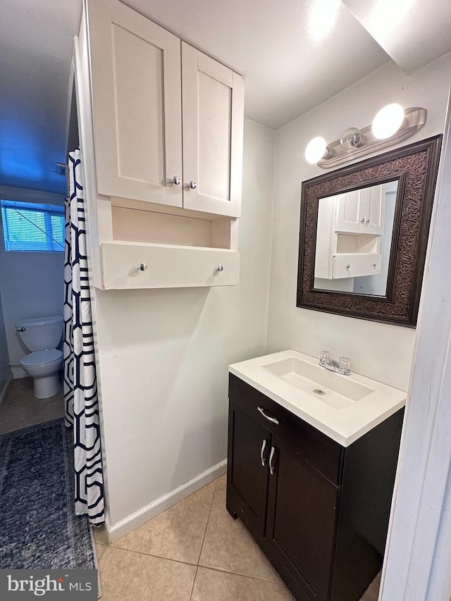 full bath featuring vanity, tile patterned floors, toilet, and baseboards