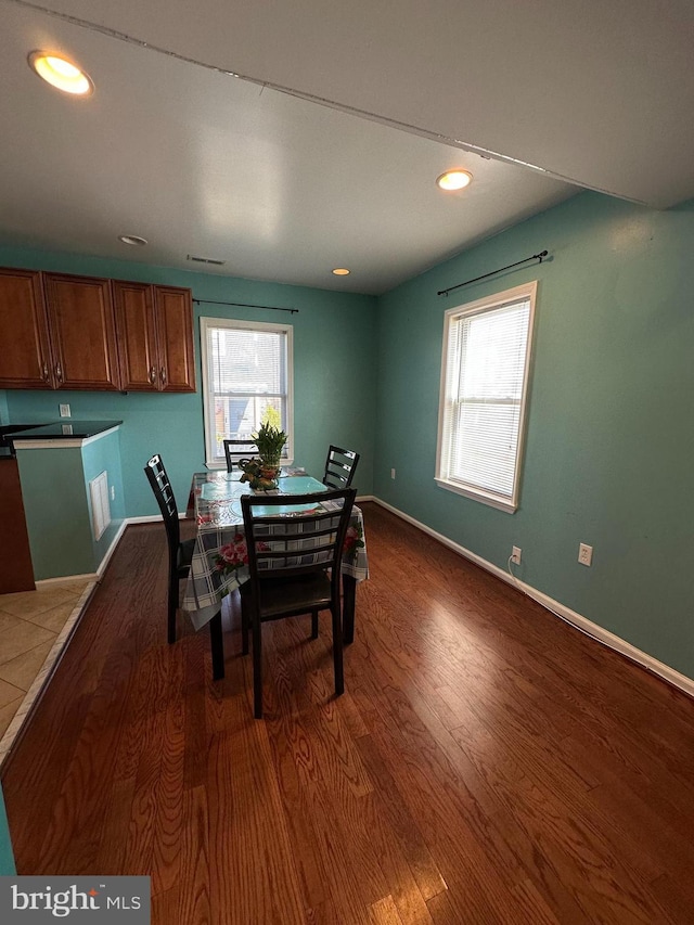 dining space featuring recessed lighting, baseboards, and dark wood-style flooring