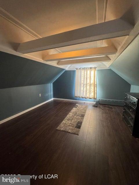 additional living space with vaulted ceiling with beams, baseboards, and dark wood-style flooring