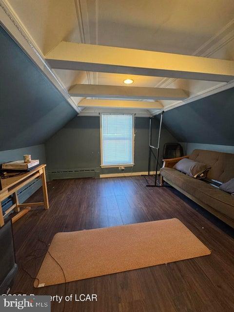 bedroom featuring lofted ceiling with beams and wood finished floors