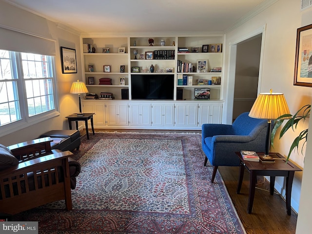 living area featuring built in features, dark wood-style flooring, and ornamental molding