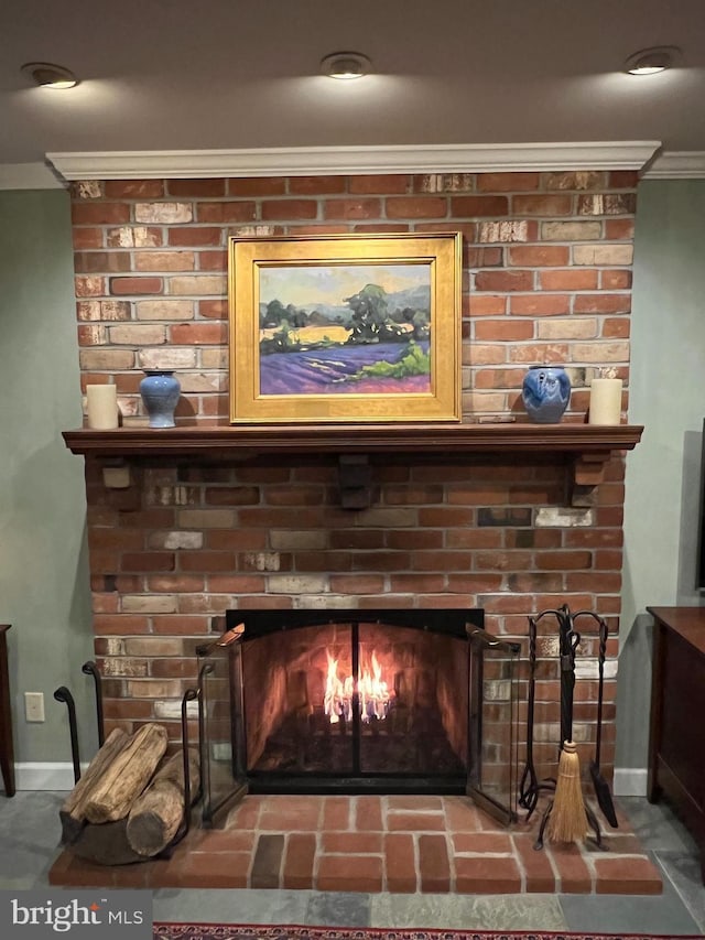 interior details featuring baseboards, a fireplace, and crown molding