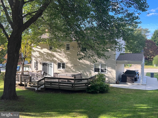 back of property with a patio, a yard, and a wooden deck