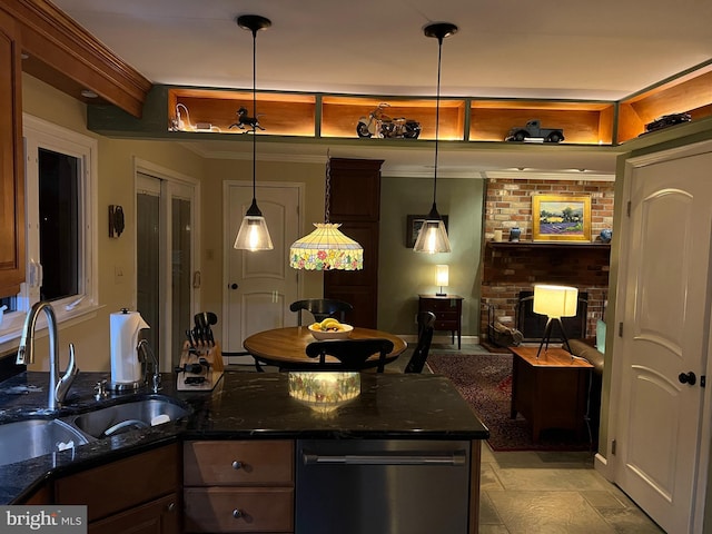 kitchen featuring a sink, dark stone counters, dishwasher, and a fireplace