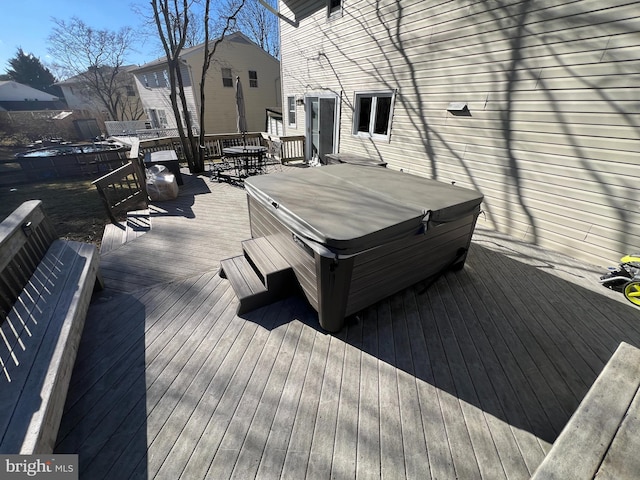 wooden deck with a hot tub