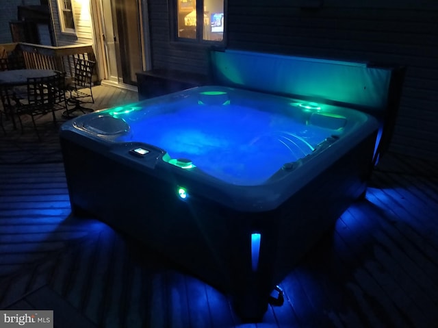 view of patio with a deck, outdoor dining space, and a hot tub