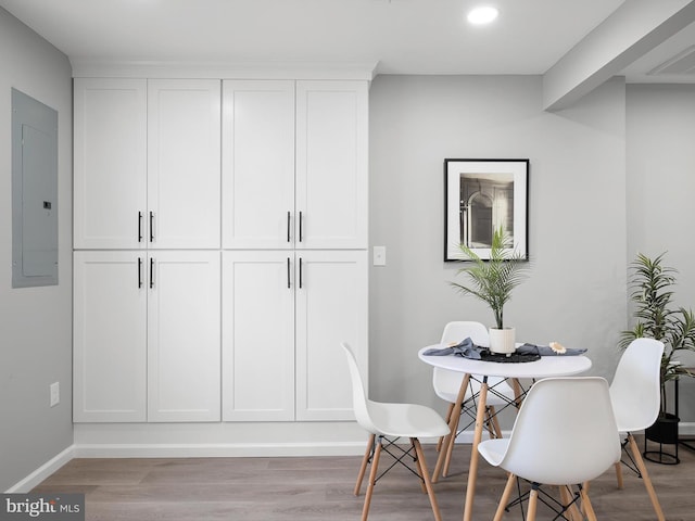 dining room featuring visible vents, baseboards, electric panel, light wood-style flooring, and recessed lighting