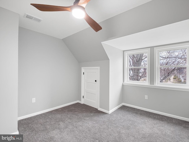 bonus room with a ceiling fan, baseboards, visible vents, carpet floors, and vaulted ceiling