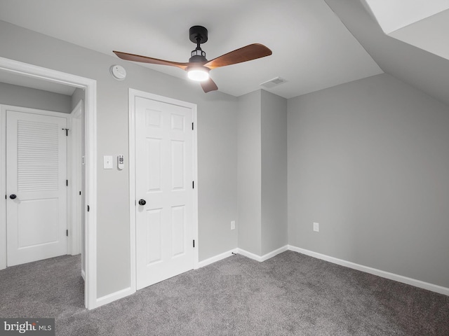 unfurnished bedroom with a ceiling fan, carpet, visible vents, and baseboards