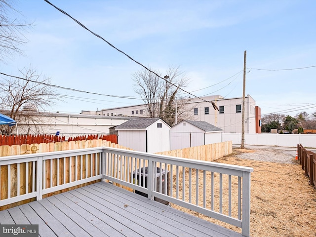 wooden deck with a fenced backyard and a residential view