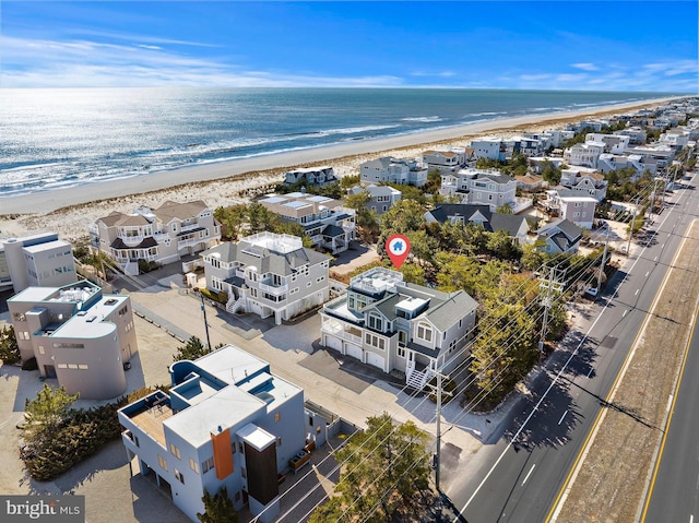 aerial view featuring a view of the beach, a residential view, and a water view