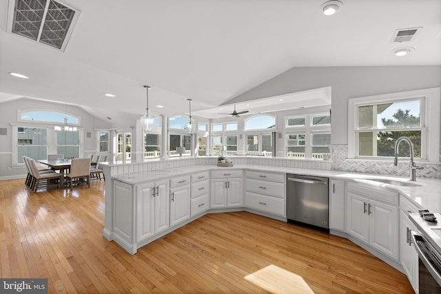 kitchen featuring a sink, visible vents, lofted ceiling, and stainless steel dishwasher