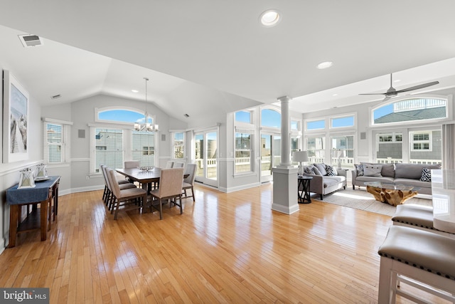 dining area with visible vents, light wood finished floors, vaulted ceiling, and ornate columns