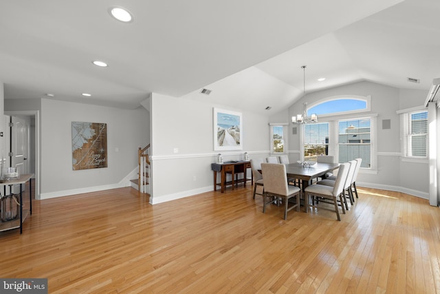 dining room featuring visible vents, light wood-style flooring, baseboards, a chandelier, and stairs