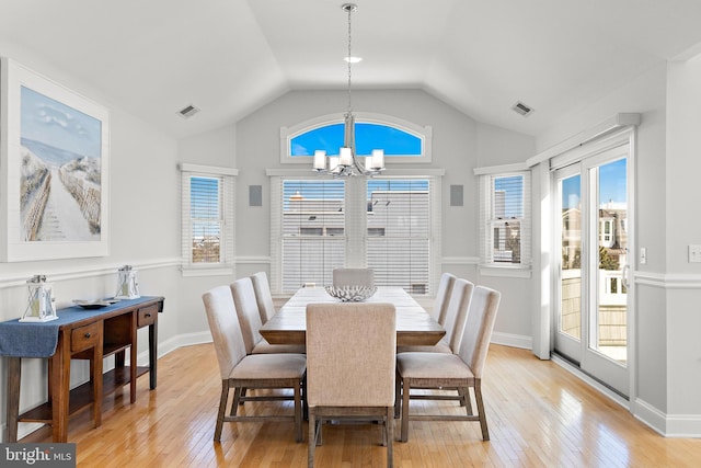 dining space featuring a notable chandelier, light wood-style floors, visible vents, and plenty of natural light