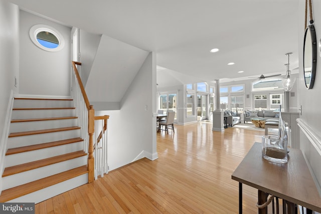 stairway featuring hardwood / wood-style flooring, decorative columns, recessed lighting, and ceiling fan