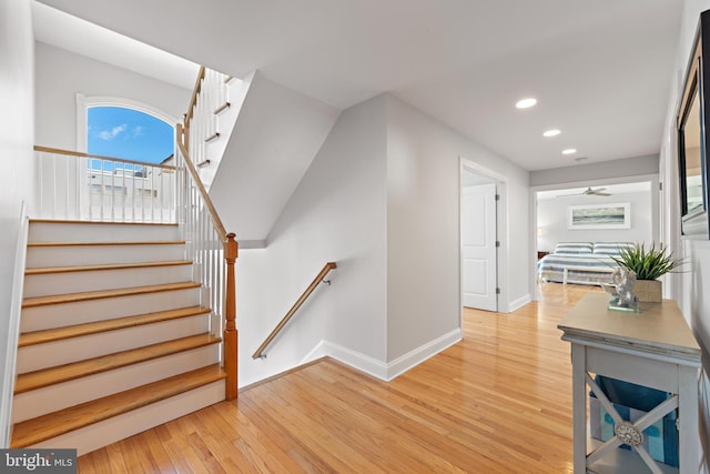 stairs with hardwood / wood-style floors, recessed lighting, and baseboards