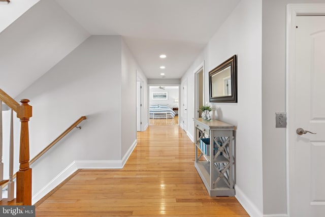 corridor with recessed lighting, baseboards, and light wood-type flooring