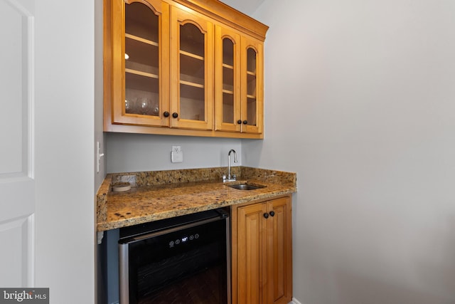 bar featuring beverage cooler, wet bar, and a sink