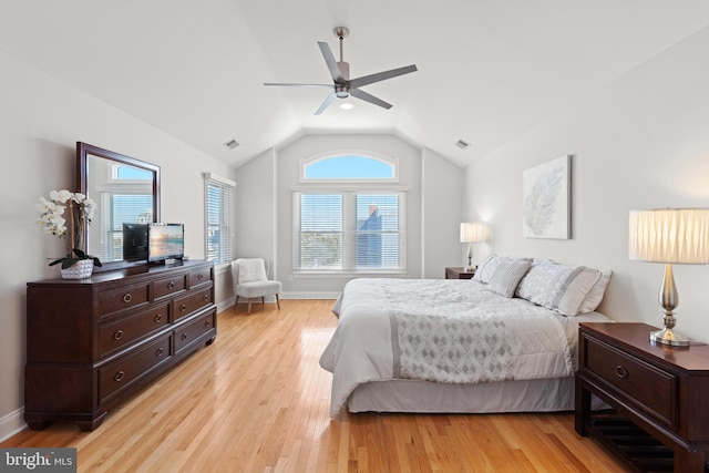 bedroom featuring visible vents, baseboards, light wood-style flooring, and vaulted ceiling