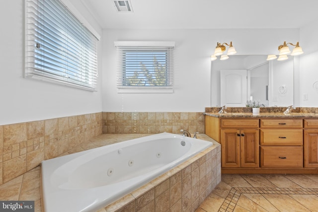 bathroom featuring visible vents, a sink, a tub with jets, and double vanity