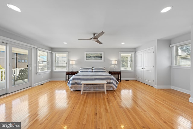 bedroom with recessed lighting, light wood-type flooring, baseboards, and access to outside