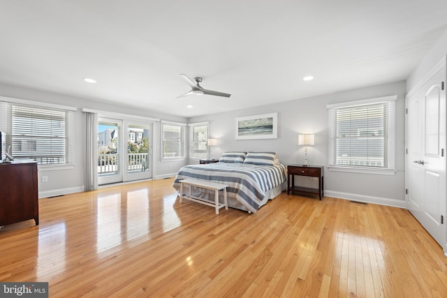 bedroom with access to exterior, light wood finished floors, and baseboards