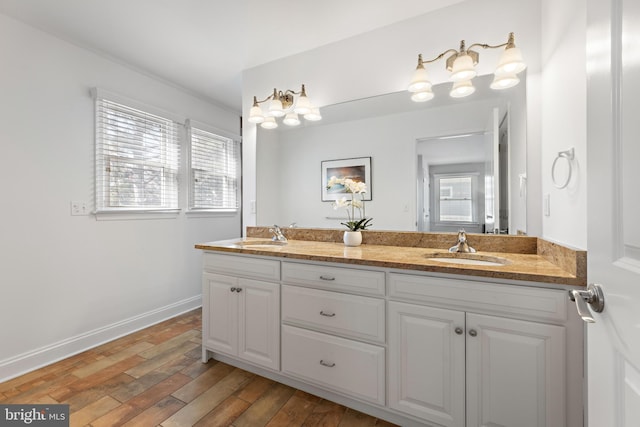 full bath with a wealth of natural light, wood finished floors, and a sink