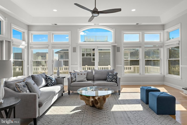 sunroom featuring a healthy amount of sunlight and a ceiling fan