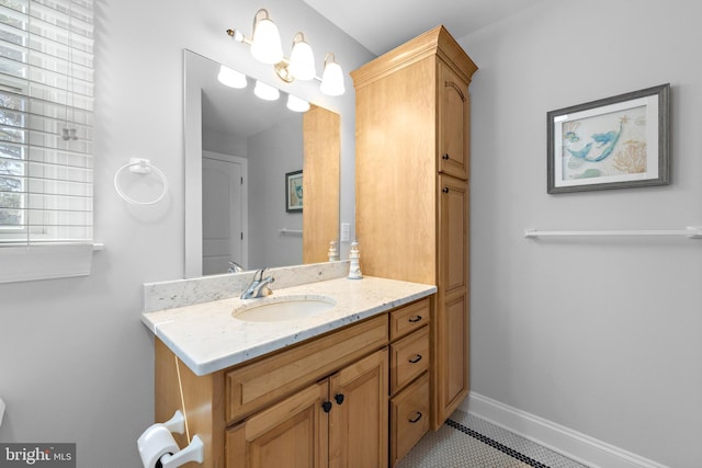 bathroom featuring vanity, tile patterned floors, and baseboards