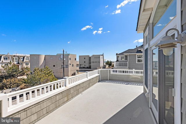 view of patio with a residential view and a balcony