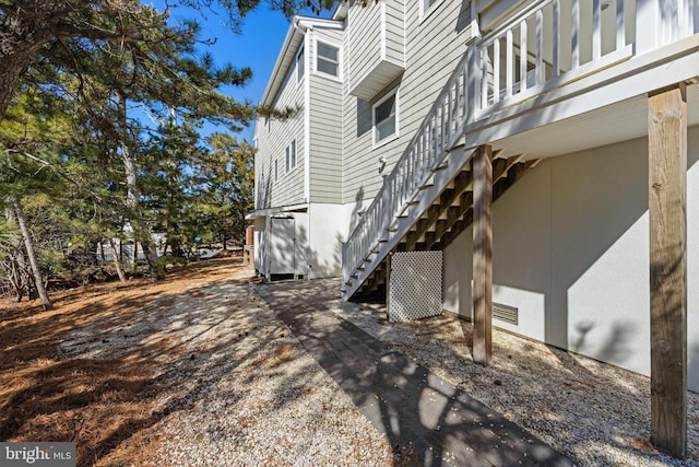 view of side of property with stairway