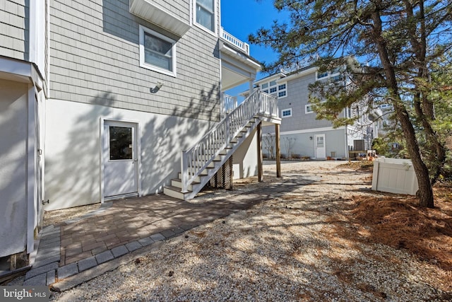 rear view of house with stairway and a patio area