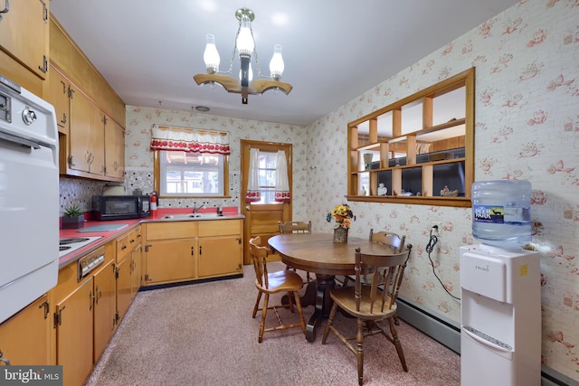 kitchen featuring a chandelier, white appliances, wallpapered walls, and a sink