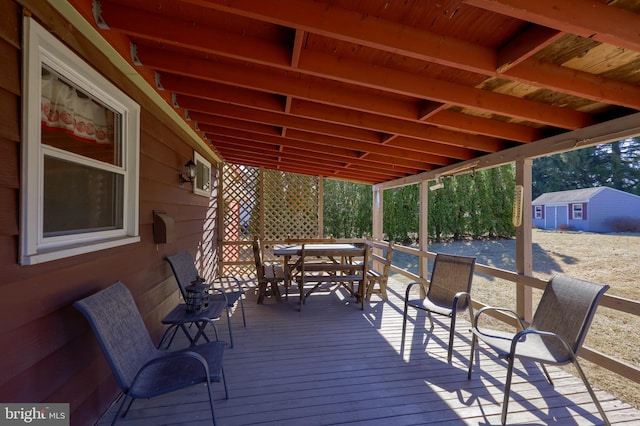 wooden terrace featuring outdoor dining area