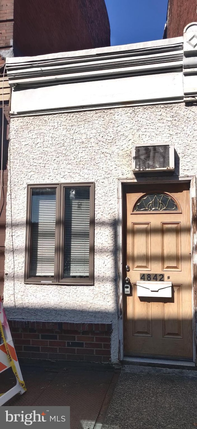 doorway to property with stucco siding