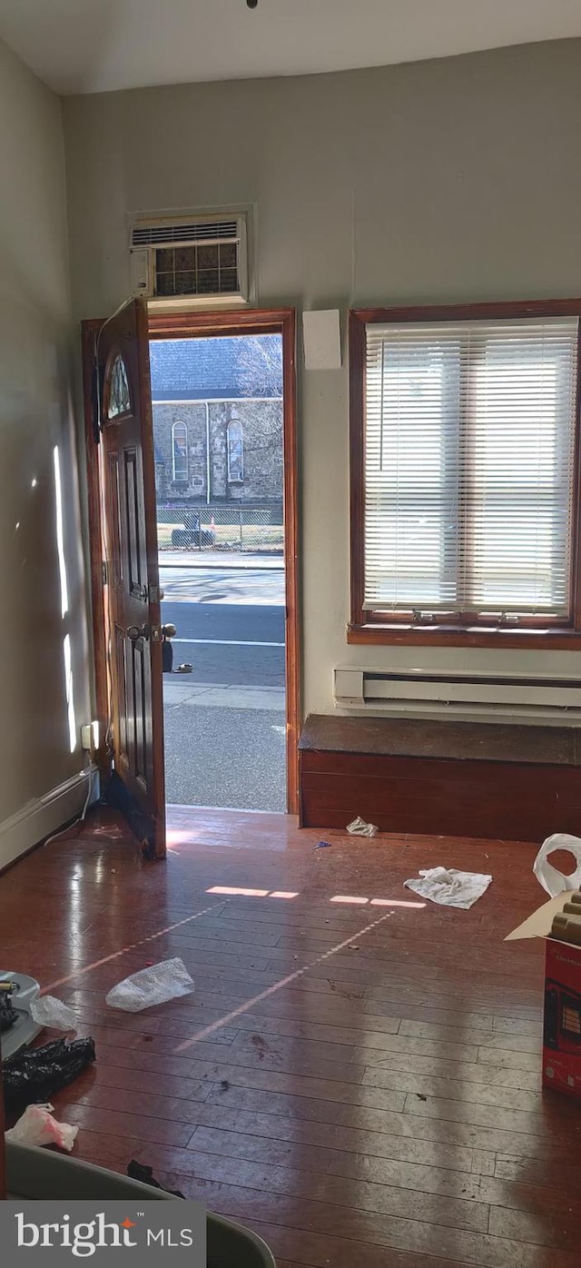 entryway with a wall mounted air conditioner and wood-type flooring