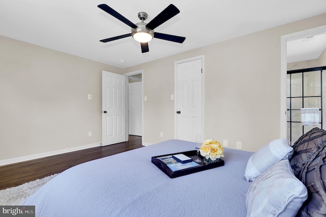 bedroom featuring ceiling fan, baseboards, and wood finished floors