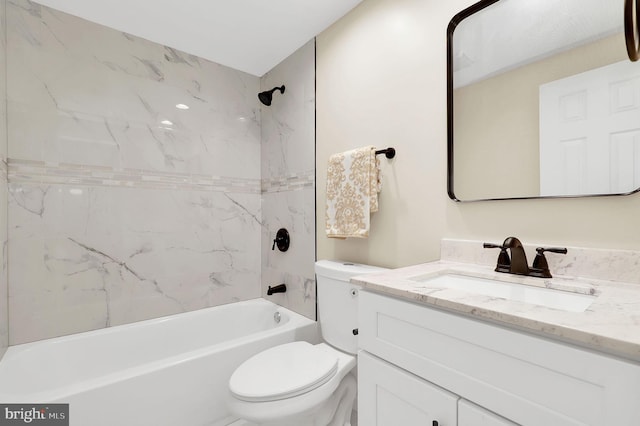 bathroom featuring toilet, vanity, and  shower combination