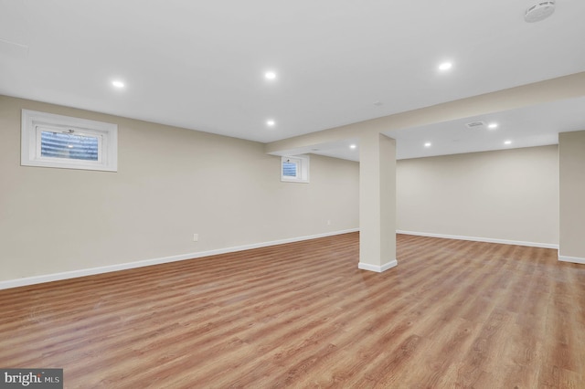 finished below grade area featuring recessed lighting, baseboards, and light wood finished floors