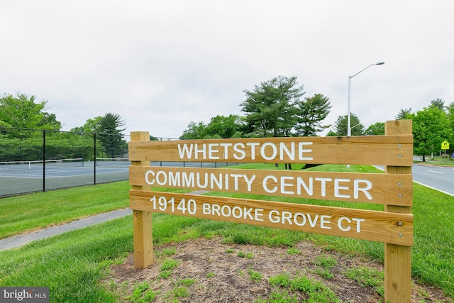 community / neighborhood sign with fence