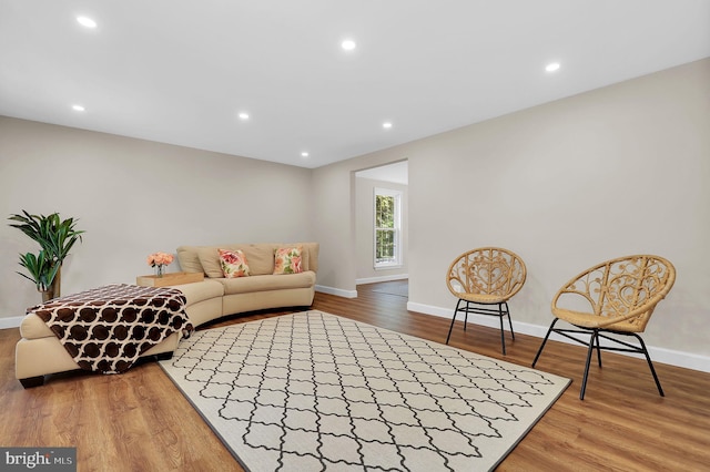 living room featuring recessed lighting, baseboards, and wood finished floors