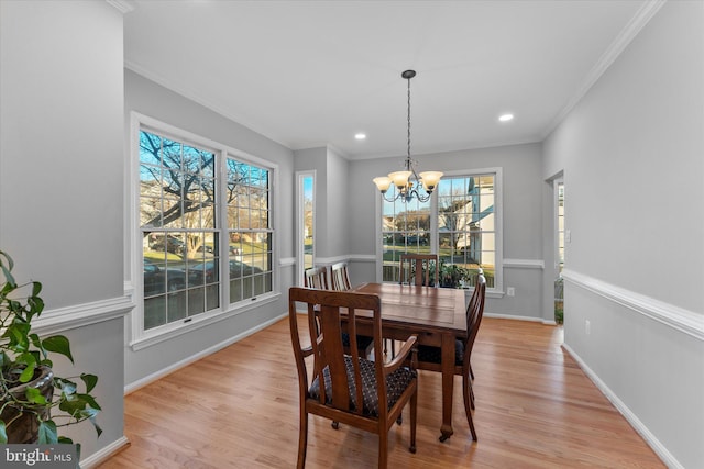 dining area featuring baseboards, plenty of natural light, light wood-style flooring, and ornamental molding