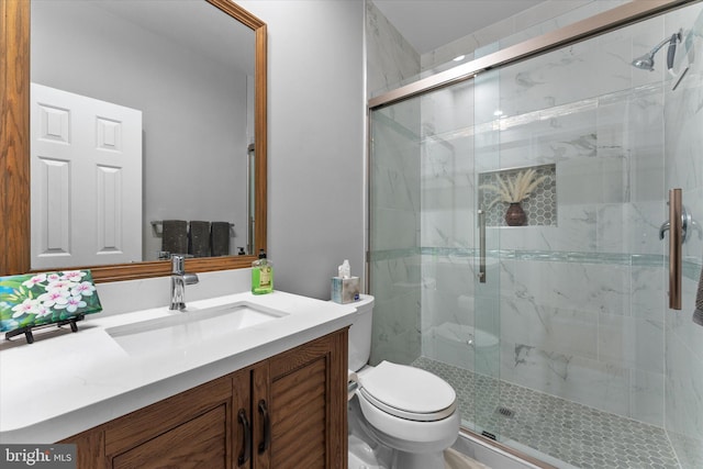 full bath featuring vanity, toilet, and a marble finish shower