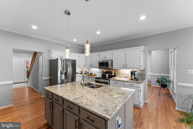 kitchen with tasteful backsplash, white cabinets, stainless steel appliances, and a sink